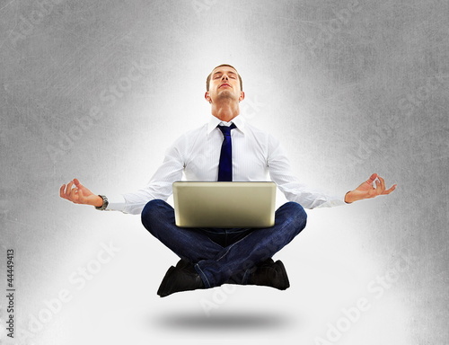 Businessman sitting in yoga position