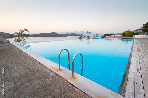 Blue swimming pool with Mirabello Bay view on Crete, Greece