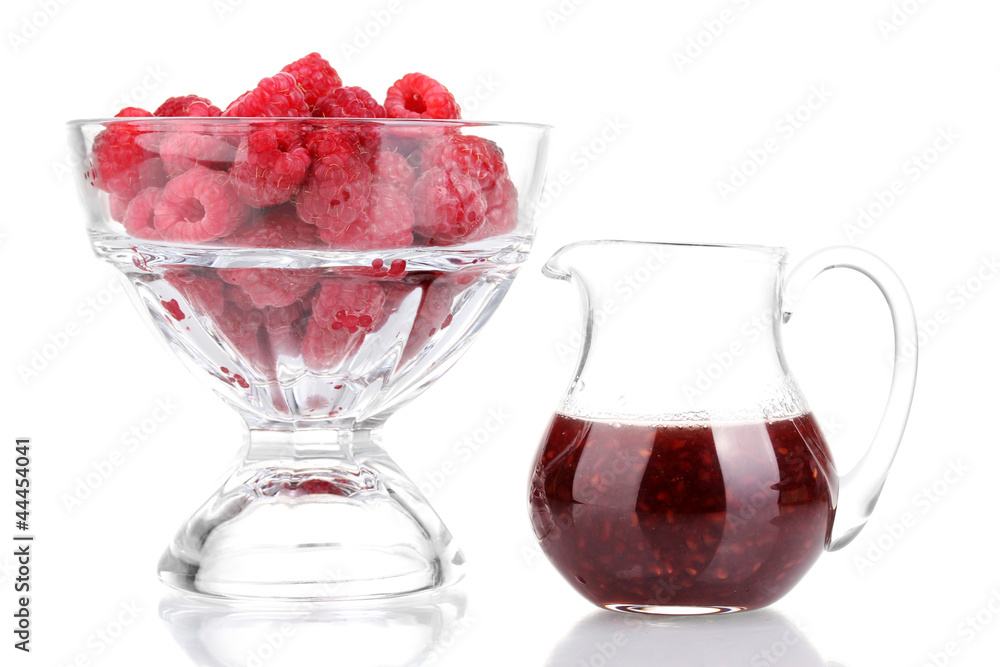 Raspberries in glass and jug with jam isolated on white Raspberries in glass and jug with jam isolated on white