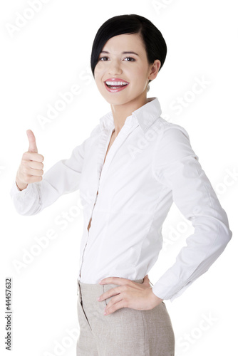 Happy smiling business woman with thumbs up gesture