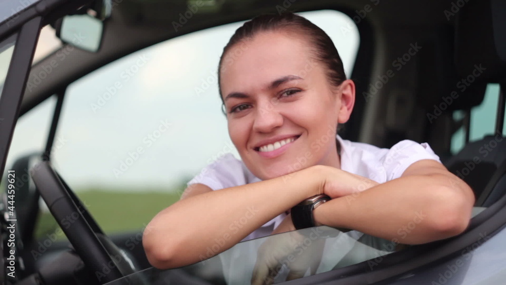 Portrait of young smiling woman sitting in the car Portrait of young smiling woman sitting in the car