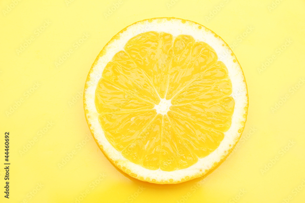 Slice of orange on yellow background Slice of orange on yellow background