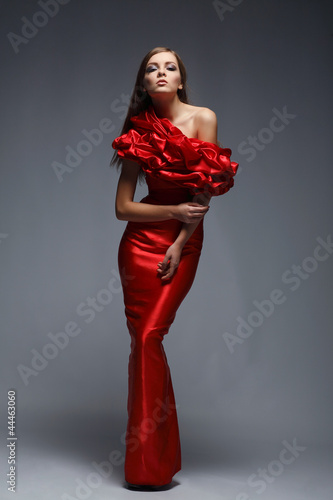 A beautiful young woman is in red clothes