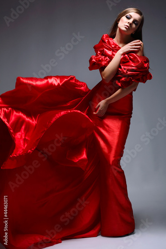 A beautiful young woman is in red clothes