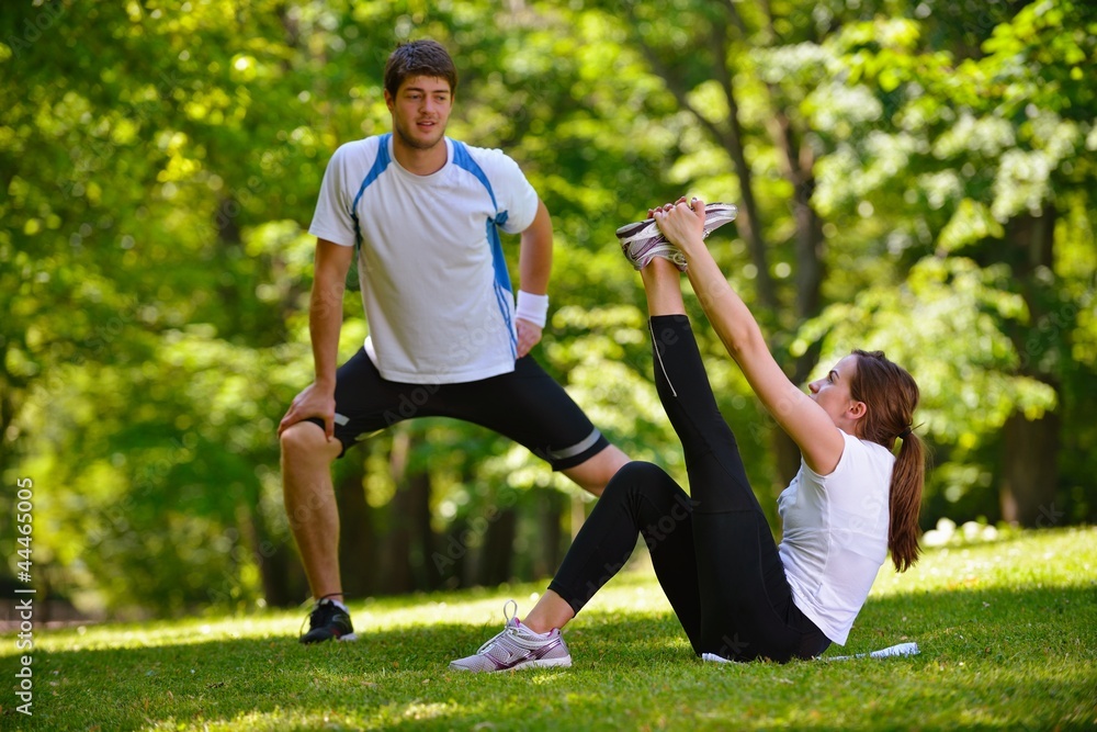 Couple doing stretching exercise after jogging Couple doing stretching exercise after jogging