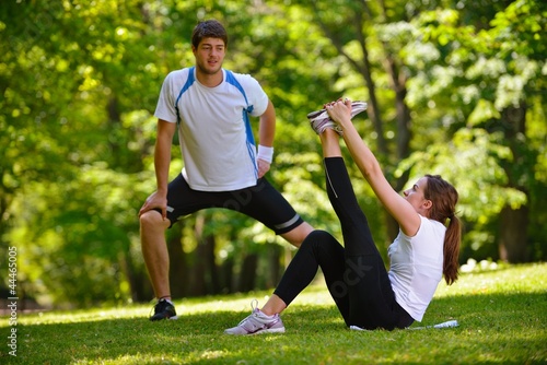 Couple doing stretching exercise after jogging