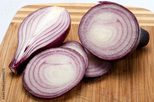 Red onions on a wooden board