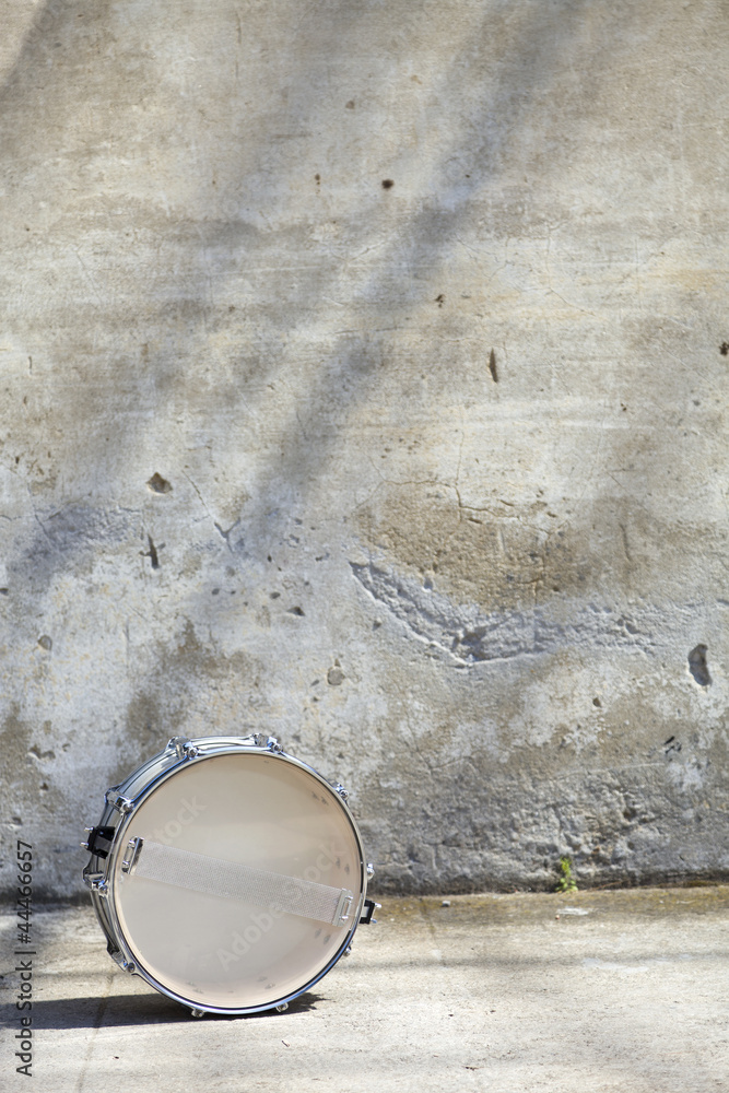 drum in front of a wall drum in front of a wall