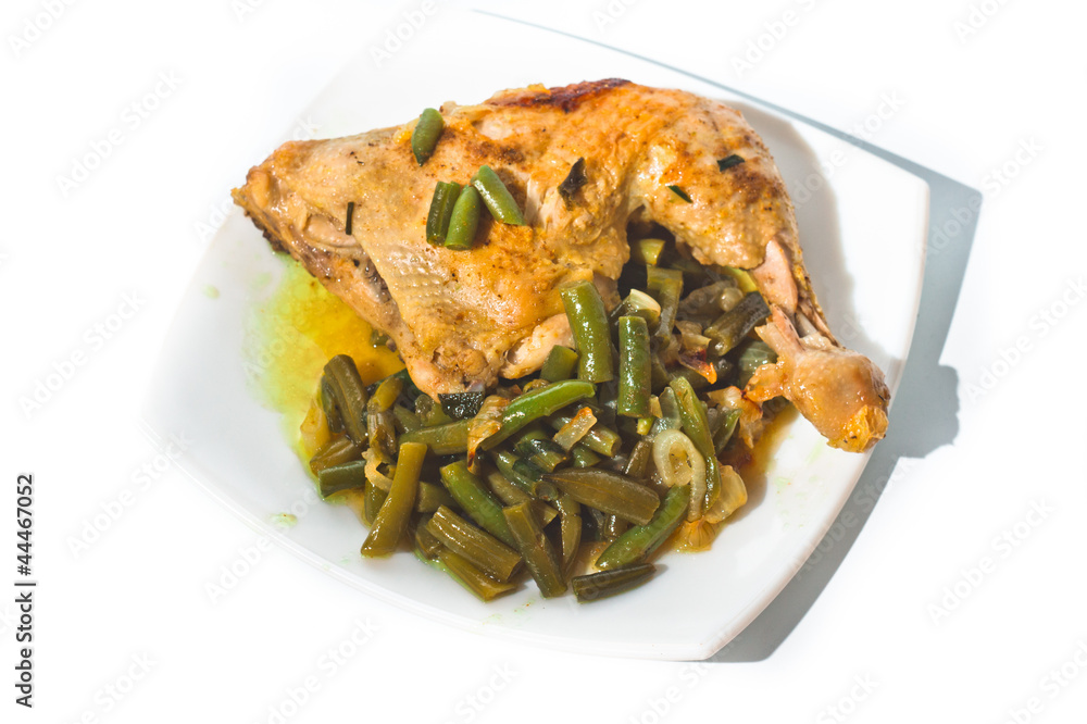 Fried chicken leg with french beans on white plate. Fried chicken leg with french beans on white plate.