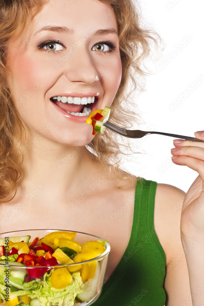 Young blonde on a white background. Useful Vegetarian eating Young blonde on a white background. Useful Vegetarian eating