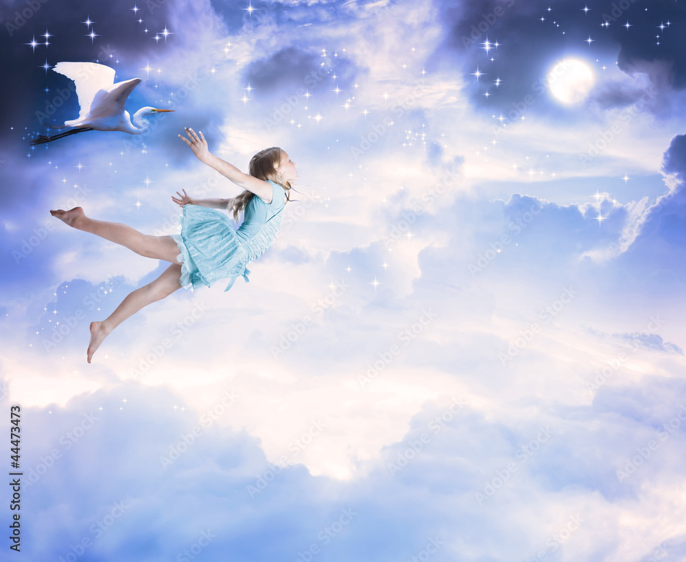 Little girl flying into the blue night sky