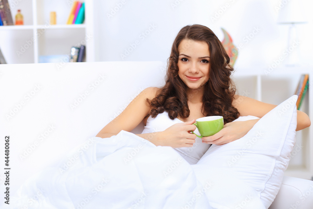 Young woman having cup of tea at home Young woman having cup of tea at home