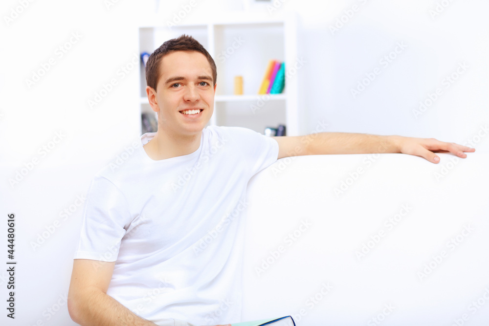 Young man at home with a book Young man at home with a book