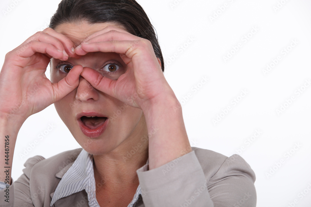 Businesswoman making a pair of glasses with her hands Businesswoman making a pair of glasses with her hands