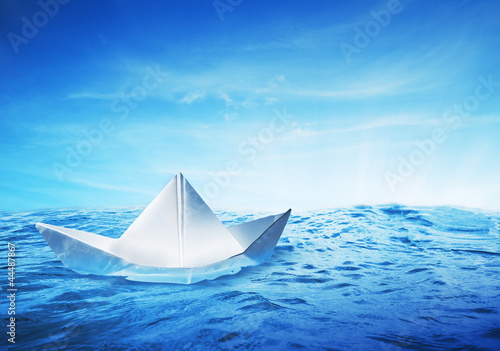 paper boat at sea on a shiny day