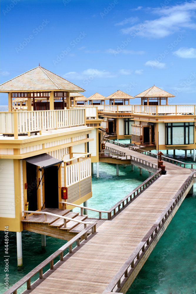 Fototapeta premium Island in ocean, overwater villa with endless swimming pools. Ma