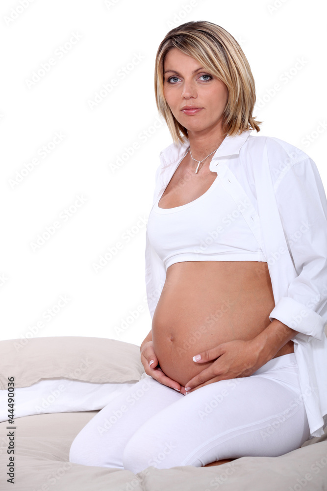 pregnant woman posing in bed pregnant woman posing in bed