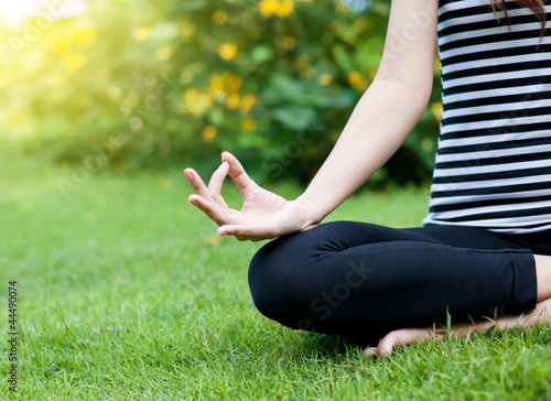 Yoga woman on green grass