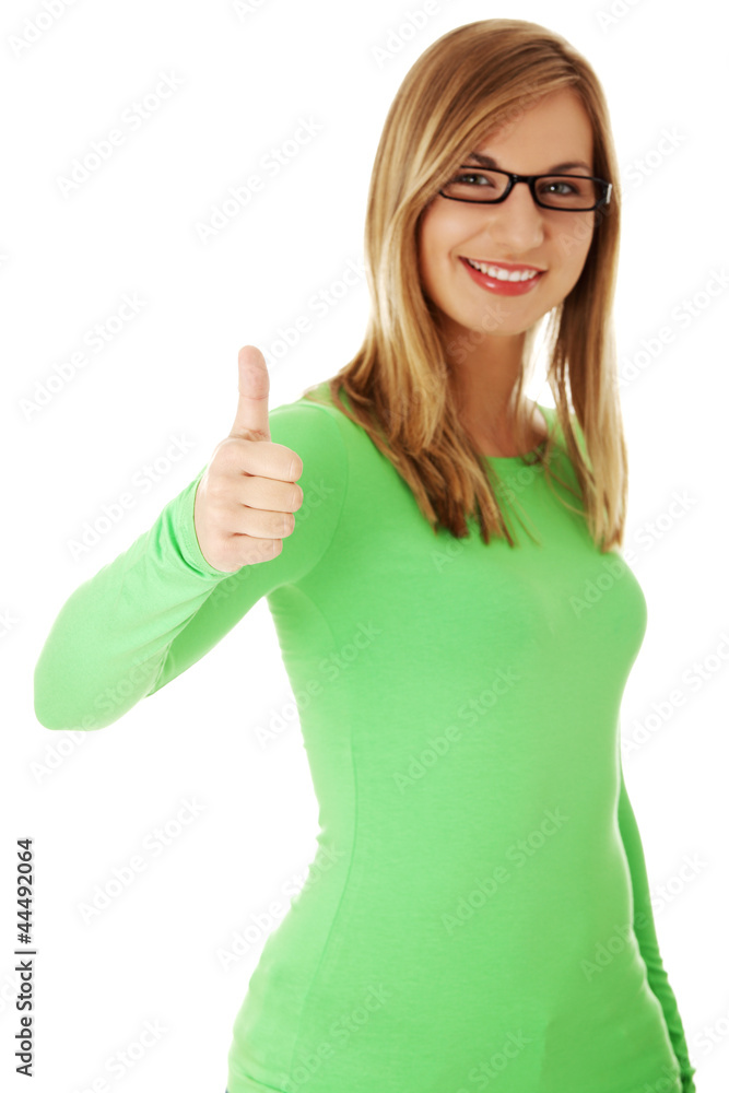 Beautiful young woman showing thumbs up sign Beautiful young woman showing thumbs up sign