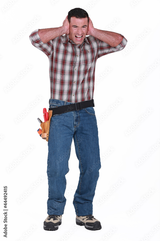 Builder with his hands over his ears Builder with his hands over his ears