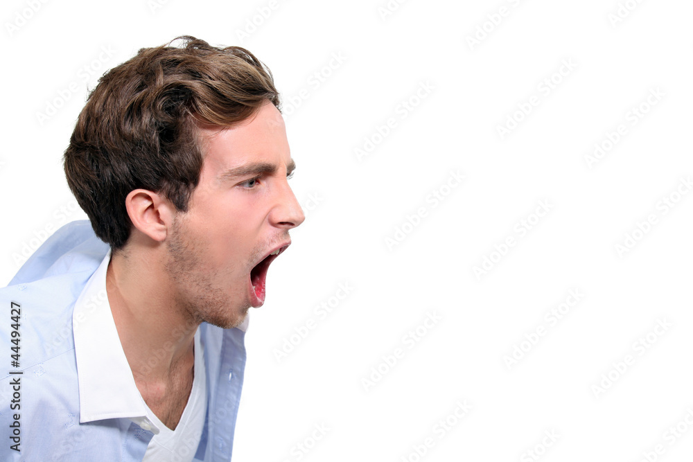 Obraz premium Young man screaming, studio shot