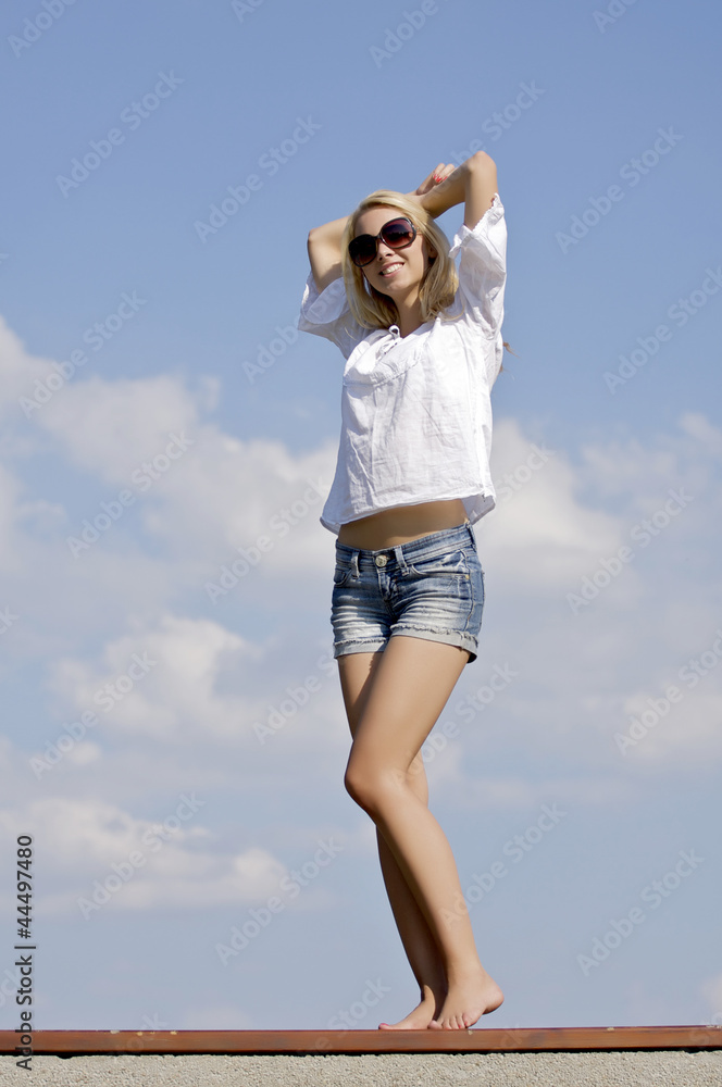 beautiful girl in sunglasses on background blue sky beautiful girl in sunglasses on background blue sky