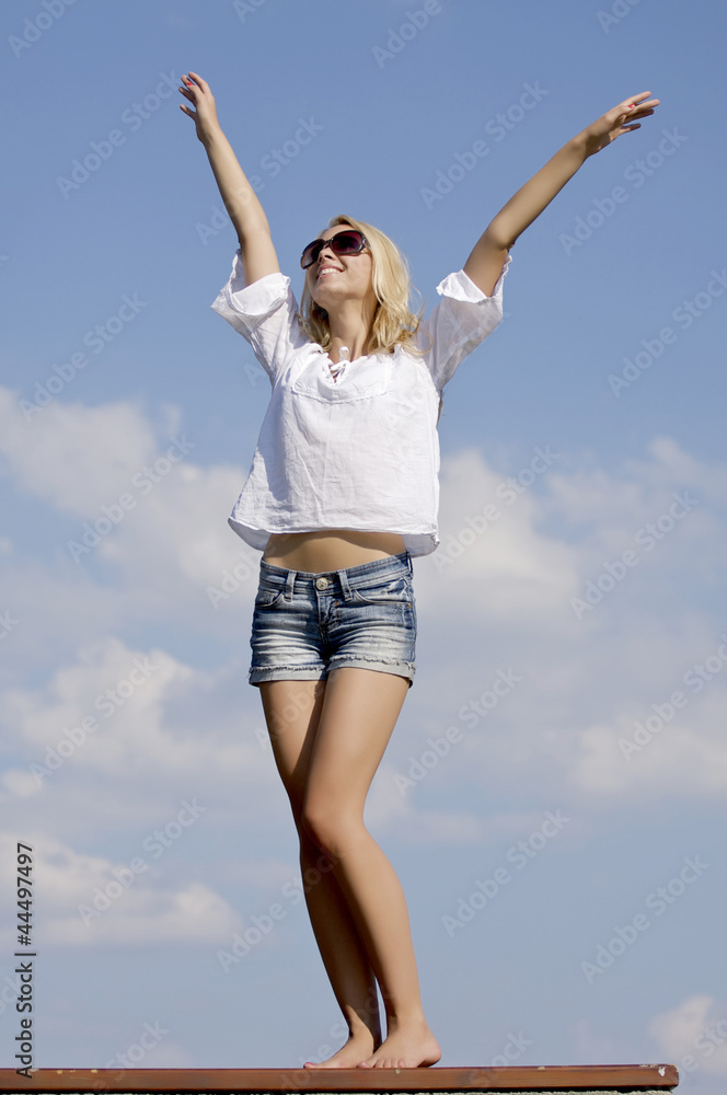 beautiful girl in sunglasses on background blue sky beautiful girl in sunglasses on background blue sky