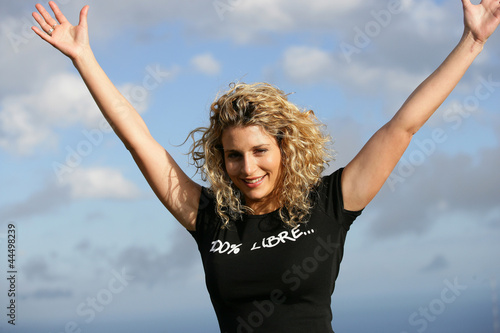 Young woman with arms up outdoors