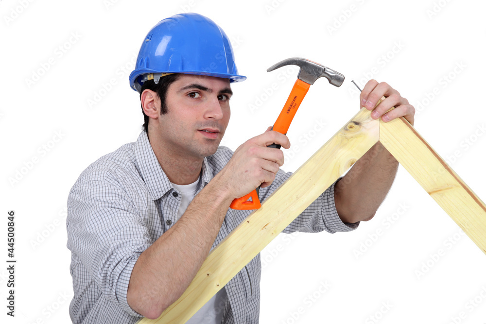 Carpenter making wooden frame Carpenter making wooden frame