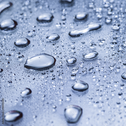 Water drops on a blue surface