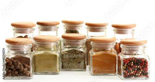 powder spices in glass jars  isolated on white