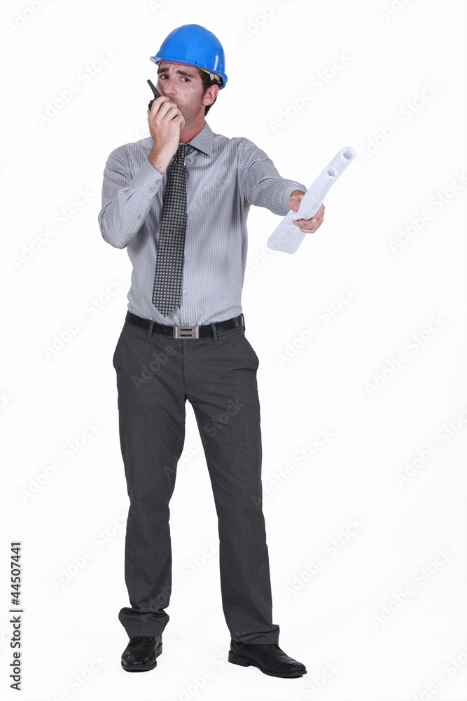 architect holding blueprints holding talkie-walkie architect holding blueprints holding talkie-walkie