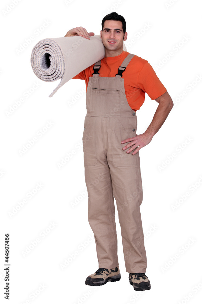 Man holding a roll of carpet Man holding a roll of carpet
