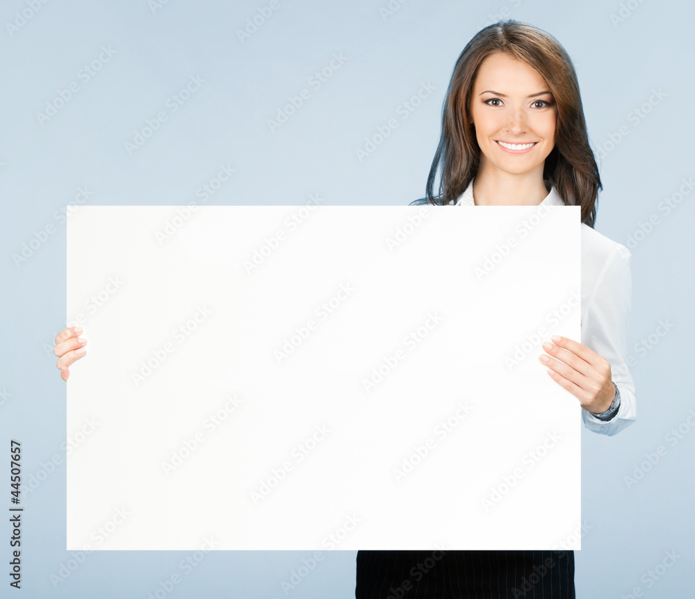 Businesswoman showing signboard, over blue Businesswoman showing signboard, over blue