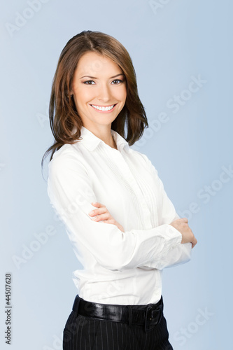 Smiling businesswoman, over blue