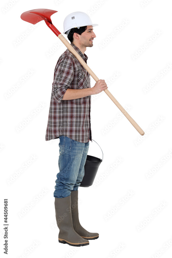 A construction worker with a shovel. A construction worker with a shovel.
