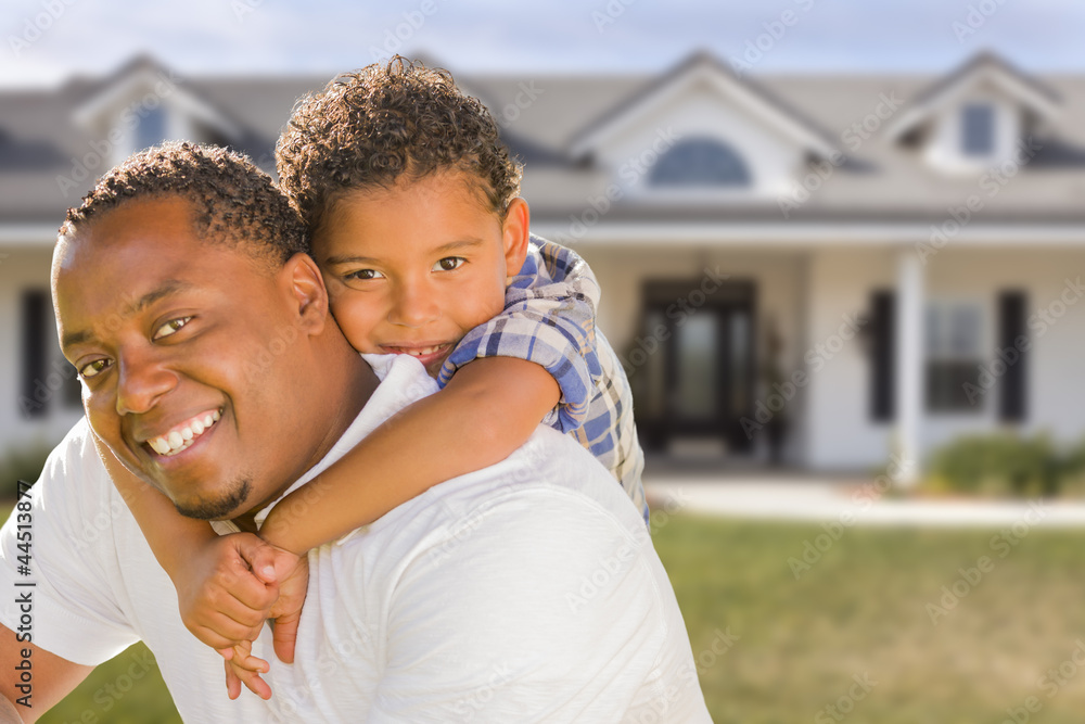 Obraz premium Mixed Race Father and Son In Front of House