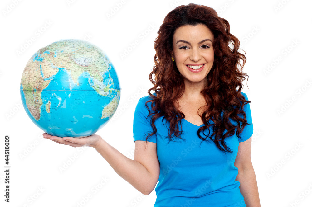 Pretty smiling girl holding globe in right hand Pretty smiling girl holding globe in right hand