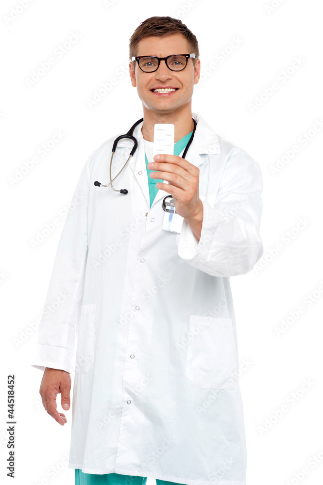 Smiling doctor showing tablets pack to camera Smiling doctor showing tablets pack to camera