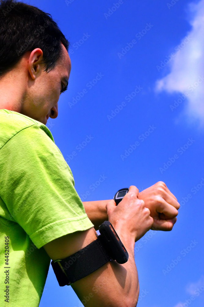 Fototapeta premium Young sporting boy with stopwatch