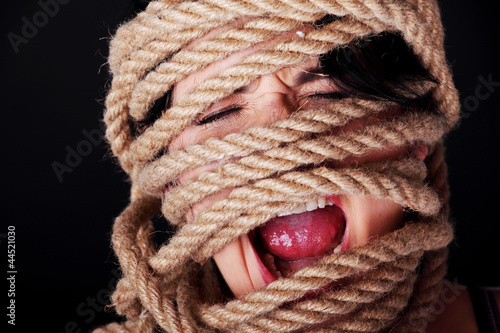 Tied up woman screaming. photo