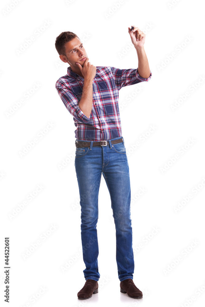 Young casual man writing on glass board with marker Young casual man writing on glass board with marker