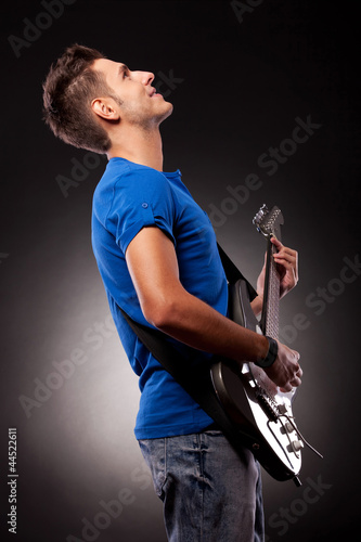 a guitarist playing his electric guitar