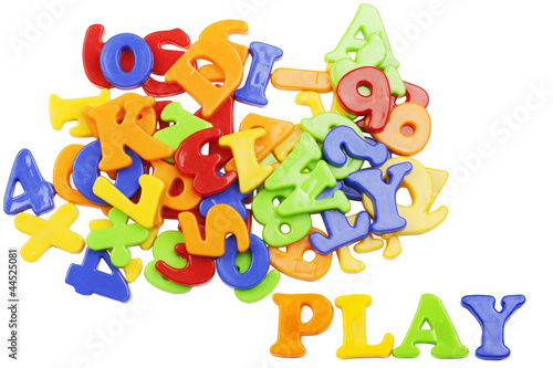 PLAY lettering near plastic alphabet letters