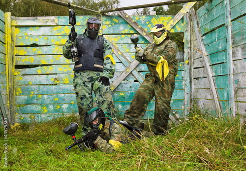 Paintball players in full gear at the shooting range photo