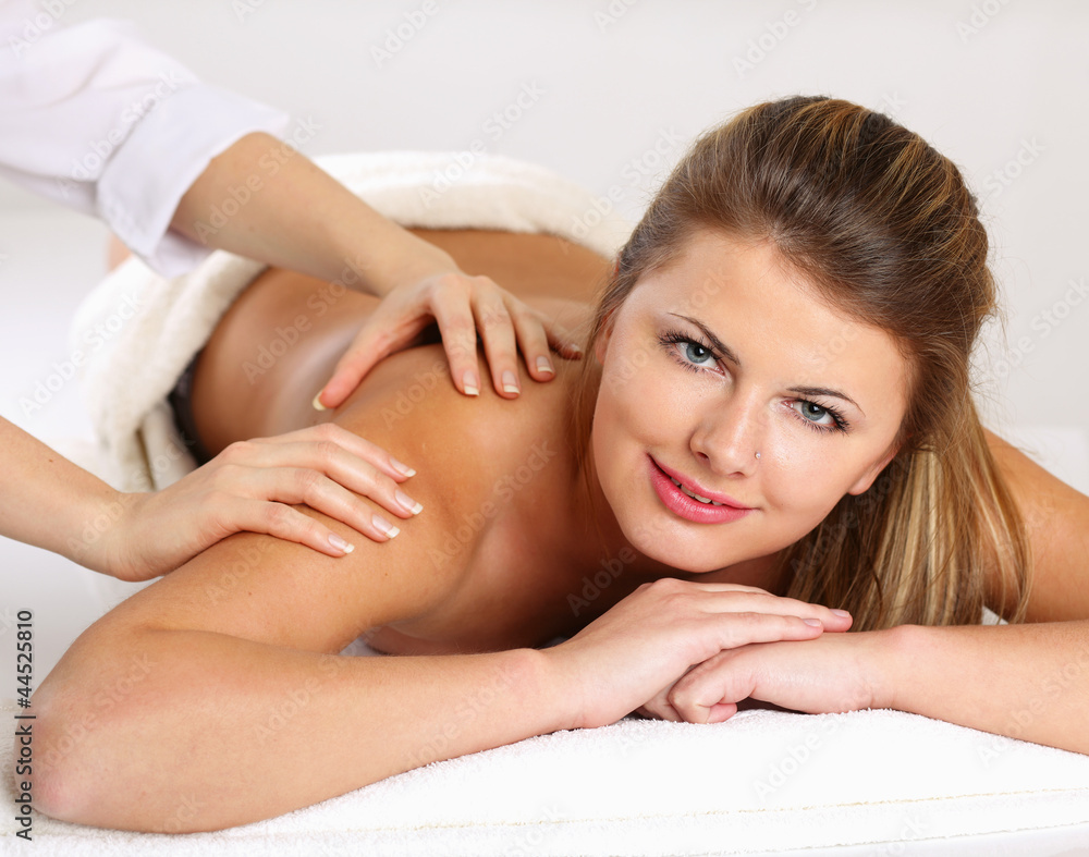 Closeup of an attractive young woman receiving massage Closeup of an attractive young woman receiving massage