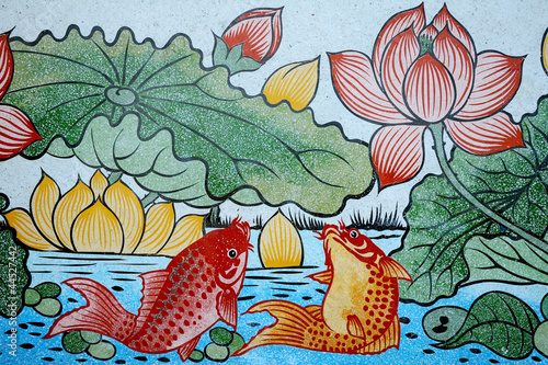 Fishes of Wealth and Lotus painting on stone wall.