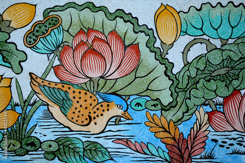 Bird and Lotus painting on stone wall.