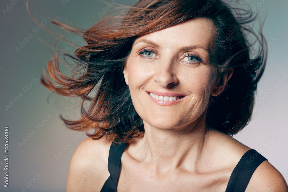 Fototapeta premium Happy middle-aged woman with curly hair.