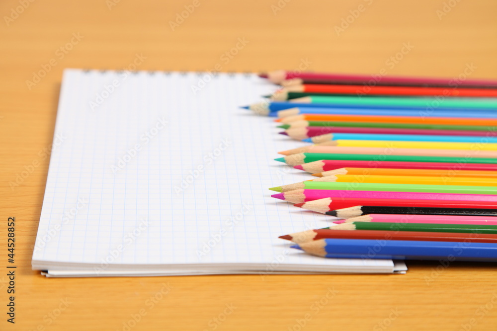 Pencils and checked notebook Pencils and checked notebook
